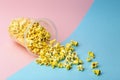 Popcorn on a colored background. Minimal food concept. Entertainment, film and video content. Aesthetics 80s and 90s concept