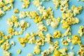 Popcorn on a colored background. Minimal food concept. Entertainment, film and video content. Aesthetics 80s and 90s concept