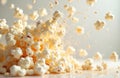 Popcorn explodes into tiny pieces and kernels, flying through the air in a dynamic burst of light yellow snack food. Deliciously Royalty Free Stock Photo