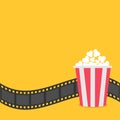 Popcorn. Film strip border. Red yellow box. Cinema movie night icon in flat design style. Yellow background. Royalty Free Stock Photo