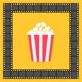 Popcorn. Film strip square frame. Red yellow box. Cinema movie night icon in flat design style. Yellow background. . Royalty Free Stock Photo