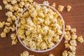 Popcorn in bowl. Brown background