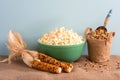 Popcorn in a Green Vintage bowl with multicolored, dried corn cobs and unpopped kernels in a container all on burlap table with bl Royalty Free Stock Photo