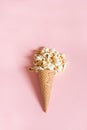 Popcorn in ice cream cones on pink background. Top view. Royalty Free Stock Photo