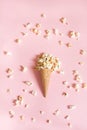 Popcorn in ice cream cones on pink background. Top view. Royalty Free Stock Photo