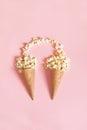 Popcorn in ice cream cones on pink background. Top view. Royalty Free Stock Photo