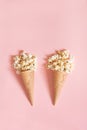 Popcorn in ice cream cones on pink background. Top view. Royalty Free Stock Photo