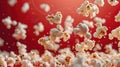 Popcorn kernels captured in mid-air with a deep red background. Royalty Free Stock Photo