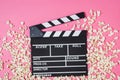 Popcorn, movie clip on pink background top view, copy space Royalty Free Stock Photo