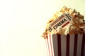 Popcorn and movie tickets on white background vintage
