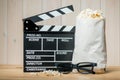 popcorn package, 3D glasses and video clapper objects of the film industry close-up