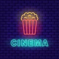 Popcorn paper bag Cinema neon banner on brick wall