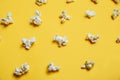 Popcorn pattern on yellow background. Top view. Film. Fast food. Corn