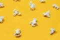 Popcorn pattern on yellow background. Top view. Film. Fast food. Corn
