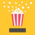 Popcorn popping. Film strip. Red yellow box. Cinema movie night icon in flat design style. Yellow background.