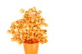 Popcorn pourring out the plastic cup isolated on the white background Royalty Free Stock Photo