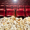 Popcorn and red cinema seats Royalty Free Stock Photo