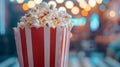 Popcorn in a red and white box with a bokeh background. Royalty Free Stock Photo