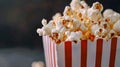 Popcorn in a red and white box with a bokeh background. Royalty Free Stock Photo