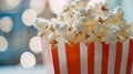 Popcorn in a red and white box with a bokeh background. Royalty Free Stock Photo