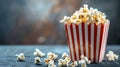 Popcorn in a red and white box with a bokeh background. Royalty Free Stock Photo