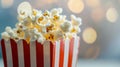 Popcorn in a red and white box with a bokeh background. Royalty Free Stock Photo