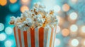 Popcorn in a red and white box with a bokeh background. Royalty Free Stock Photo