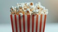 Popcorn in a red and white box with a bokeh background. Royalty Free Stock Photo