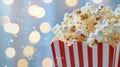 Popcorn in a red and white box with a bokeh background. Royalty Free Stock Photo