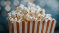 Popcorn in a red and white box with a bokeh background. Royalty Free Stock Photo