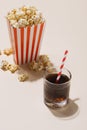 Popcorn in red and white cardboard with glass of soda Royalty Free Stock Photo