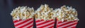 Popcorn in red and white container on a dark background BANNER, LONG FORMAT Royalty Free Stock Photo