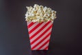 Popcorn in red and white container on a dark background Royalty Free Stock Photo