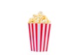 Popcorn in red and white striped cardboard bucket isolated on white background. Movie Popcorn isolated on white with clipping path Royalty Free Stock Photo
