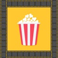 Popcorn. Red yellow box. Film strip square frame. Cinema movie night icon in flat design style. Yellow background. . Royalty Free Stock Photo