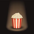 Popcorn round bucket cup in spotlight. Realistic vector cinema heaped pop corn paper bowl red white box. super star movie snack.