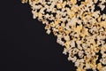 Popcorn scattered at half the dark background and a space for copyspace. Popcorn on a black background Royalty Free Stock Photo