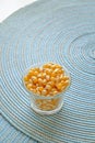 Popcorn seeds in a glass cup portrait side