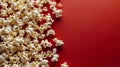 Popcorn spilled out onto a red background. Created using ai generative.