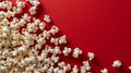 Popcorn spilled out onto a red background. Created using ai generative.