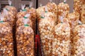 Different types of popcorn: kettle, caramel, chocolate. Popcorn stall at the stadium