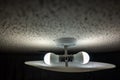 Popcorn textured ceiling with LED bulb light fixture and glass cover Royalty Free Stock Photo