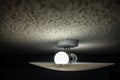 Popcorn textured ceiling with LED bulb light fixture and glass cover Royalty Free Stock Photo