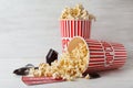 Popcorn, tickets and film footage on wooden table. Cinema snack Royalty Free Stock Photo