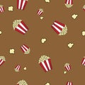 Popcorn vector seamless pattern on brown background. Popcorn is a delicious snack that you enjoy while watching movies