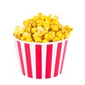 Popcorn was scattered from a large striped box, isolated on white background Royalty Free Stock Photo