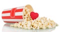 Popcorn was scattered out box and red heart on white. Royalty Free Stock Photo