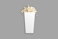 Popcorn in white cardboard bucket or box mockup isolated on white background. Royalty Free Stock Photo