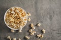 Popcorn in a white plate on a concrete background Royalty Free Stock Photo