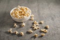 Popcorn in a white plate on a concrete background Royalty Free Stock Photo